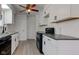 Modern kitchen with white cabinets, dark countertops, stainless steel sink, and efficient appliances at 4139 N Grand Ave, Indianapolis, IN 46226