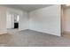 Spacious living room featuring carpet, white walls, and a view to the kitchen at 4139 N Grand Ave, Indianapolis, IN 46226