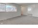 The living room features neutral walls, carpet, a barred window, and an entrance to another room at 4139 N Grand Ave, Indianapolis, IN 46226