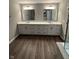Bathroom featuring double sinks with white countertop and wooden cabinets at 4187 Risen Star Way, Bargersville, IN 46106
