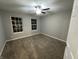Small carpeted bedroom with ceiling fan and two windows at 4187 Risen Star Way, Bargersville, IN 46106