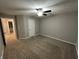 A neutral carpeted bedroom features a ceiling fan and doorway at 4187 Risen Star Way, Bargersville, IN 46106