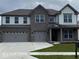 Elegant two-story home featuring a three-car garage, brick facade, and well-maintained front yard at 4187 Risen Star Way, Bargersville, IN 46106
