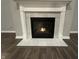 Elegant fireplace featuring a white mantel and tile surround, set against hardwood flooring at 4187 Risen Star Way, Bargersville, IN 46106