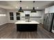 Modern kitchen with stainless steel appliances, center island, and sleek black pendant lighting at 4187 Risen Star Way, Bargersville, IN 46106