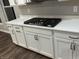 Close-up of the kitchen with white cabinets, a built-in gas cooktop, and granite countertops at 4187 Risen Star Way, Bargersville, IN 46106