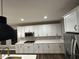 Spacious kitchen featuring white cabinetry, granite countertops, and stainless steel appliances at 4187 Risen Star Way, Bargersville, IN 46106