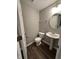 Stylish powder room with a pedestal sink, modern fixtures, and dark hardwood floors at 4187 Risen Star Way, Bargersville, IN 46106