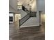 A staircase with black railings leads to the second floor and chandelier at 4187 Risen Star Way, Bargersville, IN 46106