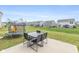 Spacious backyard featuring a patio with an outdoor table and trampoline, perfect for relaxation at 4345 Indigo Walk Ln, Indianapolis, IN 46239