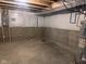 Unfinished basement with concrete floor, plastic-covered walls, visible plumbing, and exposed ceiling beams at 4345 Indigo Walk Ln, Indianapolis, IN 46239