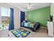 Bright bedroom with carpet, a ceiling fan, natural light, and a playful Mario-themed comforter and rug at 4345 Indigo Walk Ln, Indianapolis, IN 46239