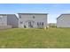 Back of house with sliding glass doors leading to patio and spacious backyard at 4345 Indigo Walk Ln, Indianapolis, IN 46239