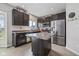 Modern kitchen with stainless steel appliances, dark cabinets, and a center island with a marble countertop at 4345 Indigo Walk Ln, Indianapolis, IN 46239