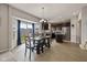 Eat-in kitchen with stainless steel appliances, dark cabinets, a kitchen island, and a view to the backyard at 4345 Indigo Walk Ln, Indianapolis, IN 46239