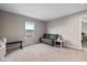 Neutral room with carpet, window for natural light and grey upholstered love seat at 4345 Indigo Walk Ln, Indianapolis, IN 46239