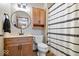 Well-lit bathroom features a vanity with wood cabinetry and a shower with a patterned curtain at 4524 Moss Creek Ter, Indianapolis, IN 46237