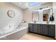 Bright bathroom with a soaking tub and double sink vanity, illuminated by a skylight at 4524 Moss Creek Ter, Indianapolis, IN 46237