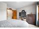 A bedroom with a television, wood dresser, and access to another room at 4524 Moss Creek Ter, Indianapolis, IN 46237