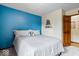 Bedroom with blue accent wall, a queen-sized bed, and carpeted floors at 4524 Moss Creek Ter, Indianapolis, IN 46237