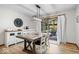 Inviting dining area with wood table, stylish light fixture, and sliding doors to outdoor patio at 4524 Moss Creek Ter, Indianapolis, IN 46237