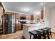Modern kitchen featuring stainless steel appliances, granite countertops, and a breakfast bar with seating at 4524 Moss Creek Ter, Indianapolis, IN 46237