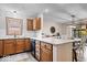 Bright kitchen featuring a large island, granite countertops, stainless steel appliances, and hardwood flooring at 4524 Moss Creek Ter, Indianapolis, IN 46237