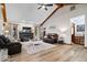 Comfortable living room featuring vaulted ceilings, hardwood floors, an electric fireplace, and a plush area rug at 4524 Moss Creek Ter, Indianapolis, IN 46237