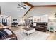 Spacious living room featuring vaulted ceilings, hardwood floors, a large area rug, and comfortable seating at 4524 Moss Creek Ter, Indianapolis, IN 46237