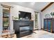 Bright living room featuring an electric fireplace, hardwood floors, a large window, and stylish decor at 4524 Moss Creek Ter, Indianapolis, IN 46237