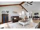 Relaxing living room boasts vaulted ceilings, hardwood floors, comfortable leather seating, and natural light at 4524 Moss Creek Ter, Indianapolis, IN 46237