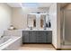 Luxurious main bathroom featuring a double vanity, soaking tub, and separate glass shower at 4524 Moss Creek Ter, Indianapolis, IN 46237
