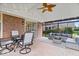 Inviting sunroom with exposed brick, outdoor furniture, and access to the patio at 4524 Moss Creek Ter, Indianapolis, IN 46237