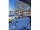 Backyard in winter with frozen lake and kayaks resting on the snowy lawn at 520 Gatewood Dr, Greenwood, IN 46143