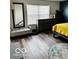 Comfortable bedroom showcasing a full-length mirror, bench seating, and a large window at 520 Gatewood Dr, Greenwood, IN 46143