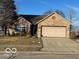Charming brick ranch home featuring an attached two-car garage, well-manicured lawn, and a welcoming entrance at 520 Gatewood Dr, Greenwood, IN 46143