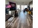Inviting living room with fireplace, hardwood floors, and sliding glass doors to the outdoors at 520 Gatewood Dr, Greenwood, IN 46143