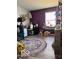 Bright office space showcasing a desk, chair, and unique decor with a purple accent wall at 520 Gatewood Dr, Greenwood, IN 46143