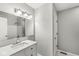 Bright bathroom featuring a marble countertop vanity, a large mirror, and classic white subway tile in the shower at 5465 Leone Dr, Indianapolis, IN 46226