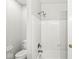 Clean and well-maintained bathroom showcasing a shower with white tiled walls and neutral-toned walls at 5465 Leone Dr, Indianapolis, IN 46226