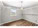 This bedroom features hardwood floors, a closet, and light fixtures at 5465 Leone Dr, Indianapolis, IN 46226