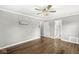 A spacious bedroom includes hardwood floors, a ceiling fan, and neutral paint at 5465 Leone Dr, Indianapolis, IN 46226