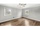 This bedroom features hardwood floors, two windows and neutral paint at 5465 Leone Dr, Indianapolis, IN 46226