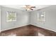 This bedroom features hardwood floors, two windows and neutral paint at 5465 Leone Dr, Indianapolis, IN 46226