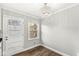 This dining area features hardwood floors, a modern chandelier and a window letting in natural light at 5465 Leone Dr, Indianapolis, IN 46226