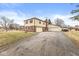 The two-car attached garage and additional garage are connected by a long driveway, adding to the charm of the house at 5465 Leone Dr, Indianapolis, IN 46226