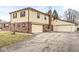 The two-car attached garage and additional garage are connected by a long driveway, adding to the charm of the house at 5465 Leone Dr, Indianapolis, IN 46226