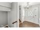 Bright foyer with chandelier, stylish front door, and wood-look flooring at 5465 Leone Dr, Indianapolis, IN 46226