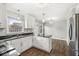 Kitchen featuring white cabinets, black countertops, stainless steel appliances and stylish lighting at 5465 Leone Dr, Indianapolis, IN 46226