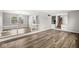 Spacious living room features wood-look flooring and seamless access to adjoining spaces at 5465 Leone Dr, Indianapolis, IN 46226